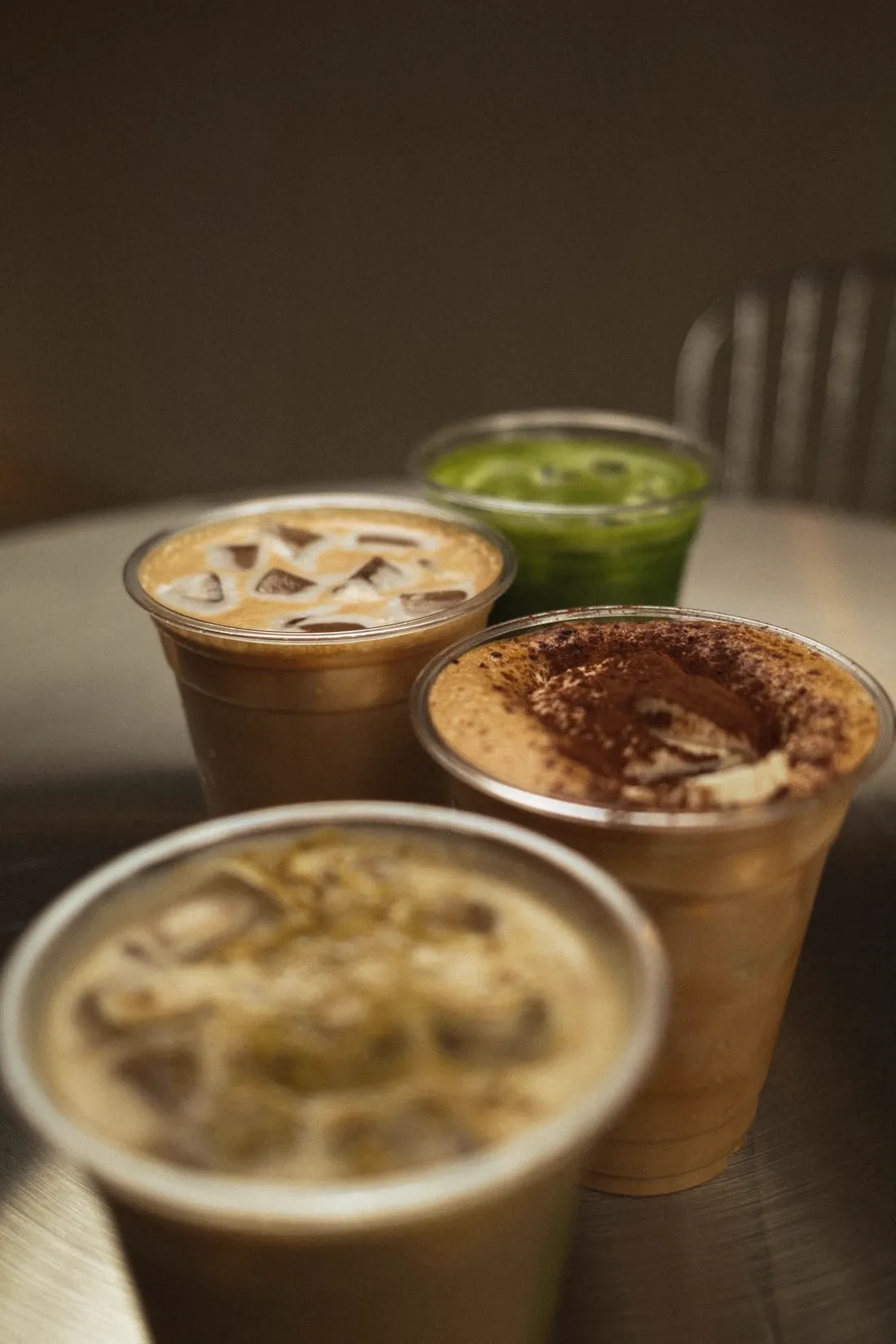 Iced lattes and a matcha on a café table